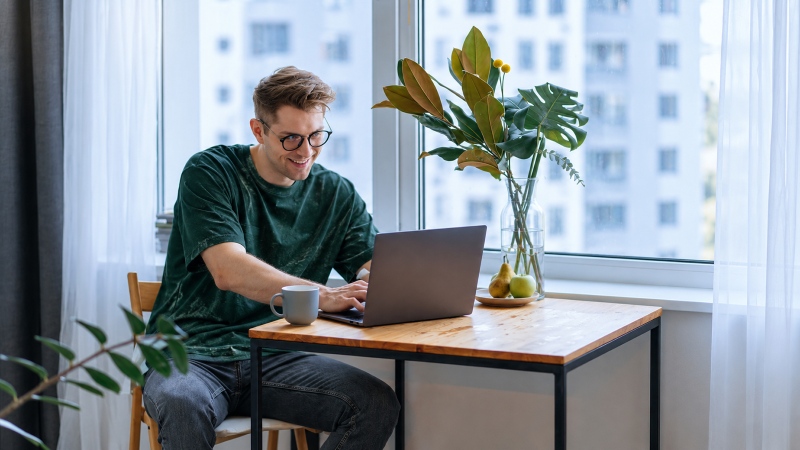 Ragazzo seduto che lavora al pc